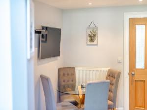 a dining room with a glass table and chairs at Ryburn House - Uk43518 in Thornton Dale