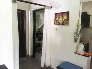 ein Zimmer mit einer Türöffnung und einem weißen Vorhang in der Unterkunft Hibiscus in Mambrui in Mambrui + 3 Fotos