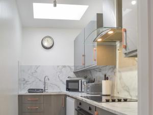 a kitchen with a sink and a microwave at Bell Tower B in Berwick-Upon-Tweed