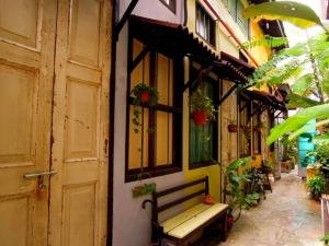 a bench sitting outside of a building with plants at MoonTree47 in George Town