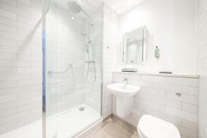 a bathroom with a shower and a toilet and a sink at Toby Carvery Beckenham by Innkeeper's Collection in Bromley