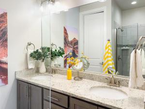 a bathroom with two sinks and a large mirror at Stargazer – Luxury Condo, Rooftop Views, Private Hot Tub in St. George +75 photos