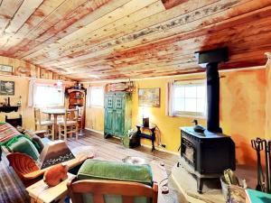 a living room with a fireplace and a stove at Willowhaven in Ruidoso