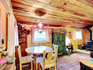 a dining room with a table and a green door at Willowhaven in Ruidoso