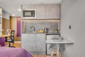 a small kitchen with a sink and a microwave at Practical Studio For 2 In Leeds with Free Grab&Go Breakfast in Headingley +9 photos