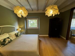 a bedroom with two chandeliers hanging from the ceiling at Casa dì in Florence +9 photos