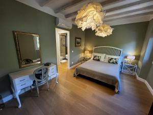 a bedroom with a bed and a mirror and a chandelier at Casa dì in Florence