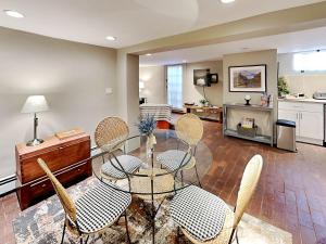 a living room with a glass table and chairs at Casa en Canyon in Santa Fe