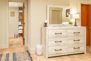 a dresser in a hallway with a mirror at Casa en Canyon in Santa Fe +6 photos