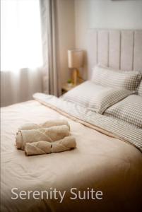 a stuffed animal is laying on a bed at Serenity Suite at OneSpatial-Iloilo in Iloilo City