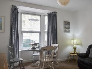 a living room with a table and chairs and a window at Apartment 1 - Uk44165 in Bridlington