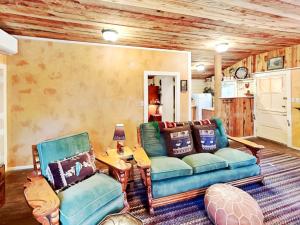 a living room with a couch and two chairs at Willowhaven in Ruidoso