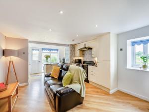 Una sala de estar con un sofá y una cocina. en Beacon - Uk44719, en Ravenscar