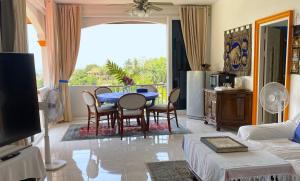 a living room with a blue table and chairs at EXCLUSIVE VILLA, four or five bedrooms in Karon Beach