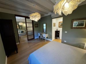 a bedroom with a bed and a dining room at Casa dì in Florence