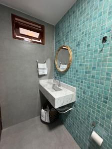 ein Badezimmer mit Waschbecken und Spiegel in der Unterkunft Casa vista mar a 20 metros da praia de garça torta em Maceio in Maceió + 29 Fotos