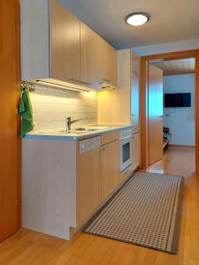 a kitchen with a sink and a microwave at Appartement Elisabeth in Schoppernau