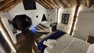 Postel nebo postele na pokoji v ubytování Hobbit Hotel El peñol Guatapé