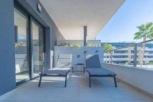 two chairs and a table on a balcony at Azure Libra Apartment Flamenca Village in Orihuela Costa