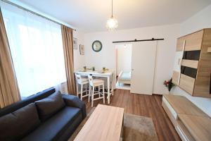 a living room with a couch and a table at FLH - The Great Novel in Sibiu
