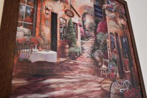 a painting of a street with a table at FLH - The Great Novel in Sibiu