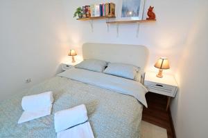 a bedroom with a large bed with two night stands at FLH - The Great Novel in Sibiu