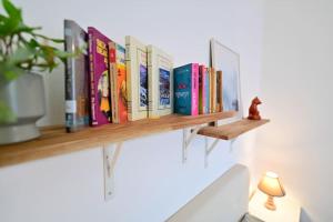 a row of books on a wooden shelf at FLH - The Great Novel in Sibiu
