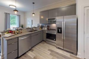 a kitchen with a stainless steel refrigerator and cabinets at Great Location 1 Bedroom Sleeps 4 in Nashville