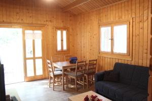 a living room with a table and chairs and a couch at Camping Tropical Almunecar in Almuñécar
