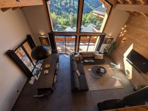 an overhead view of a living room with a large window at Sophisticated, Relaxed Chic - Chalet Sika rented Sunday-Sunday in Vaujany
