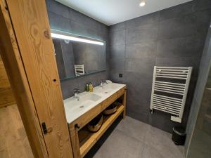 a bathroom with a sink and a mirror at Sophisticated, Relaxed Chic - Chalet Sika rented Sunday-Sunday in Vaujany +25 photos