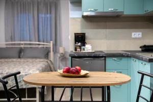 a bowl of fruit sitting on a table in a room at Trikala Wander Stay in Tríkala