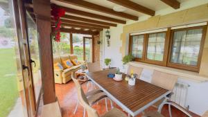 a dining room with a wooden table and chairs at La torrevia in Santillana del Mar