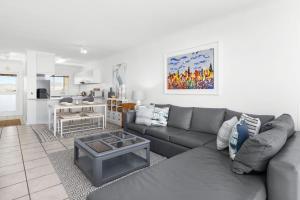 a living room with a couch and a table at Odeon Towers 1102 in Strand