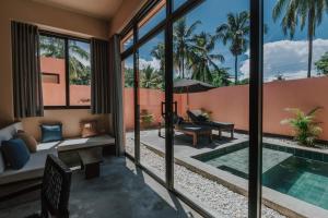 a villa with a swimming pool and a patio at Casa Ita - Private Villas in Palomino