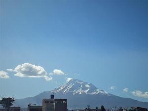 a snow covered mountain in the background of a city at Suite Boreal in Riobamba
