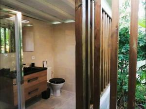 a bathroom with a toilet and a sink at Villa Ti Gîte - Piscine privée in Le Marin +16 photos