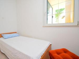 a small bedroom with a bed and a window at House Vale in Jadrija