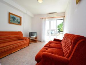 a living room with a couch and a tv at House Vale in Jadrija
