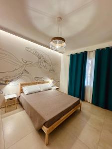 ein Schlafzimmer mit einem Bett und einem Gemälde an der Wand in der Unterkunft MSApartments in Marina di Ragusa + 35 Fotos