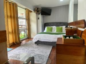 a bedroom with a large bed with green pillows at Rooftop Rooms in Male City