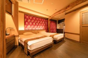 Postel nebo postele na pokoji v ubytování 都電屋 TodenHotel