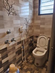 a bathroom with a toilet and a shower at Le Grace Sivaganga in Sivaganga