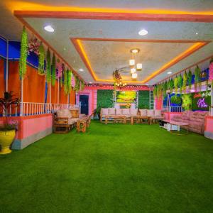 a room with pink and green carpet and tables at Exclusive Rooftop Retreat in Nairobi