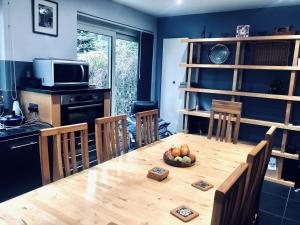 a kitchen with a wooden table with a bowl of fruit on it at Bassett Home - Double Room And Free Parking in Southampton