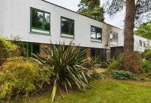 a house with green windows and a tree at Bassett Home - Double Room And Free Parking in Southampton
