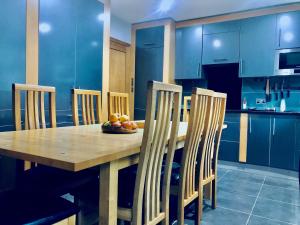 a kitchen with a wooden table and four chairs at Bassett Home - Double Room And Free Parking in Southampton