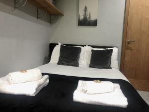 a bedroom with a large bed with towels on it at Bassett Home - Double Room And Free Parking in Southampton