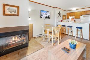a living room with a fireplace and a table and chairs at SC105B 1BR 1BA Sleeps Six Wi-Fi Free Parking Close To Lift in Snowshoe