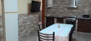 a kitchen with a table with a white table cloth at Casa Quequén in Quequén +4 photos